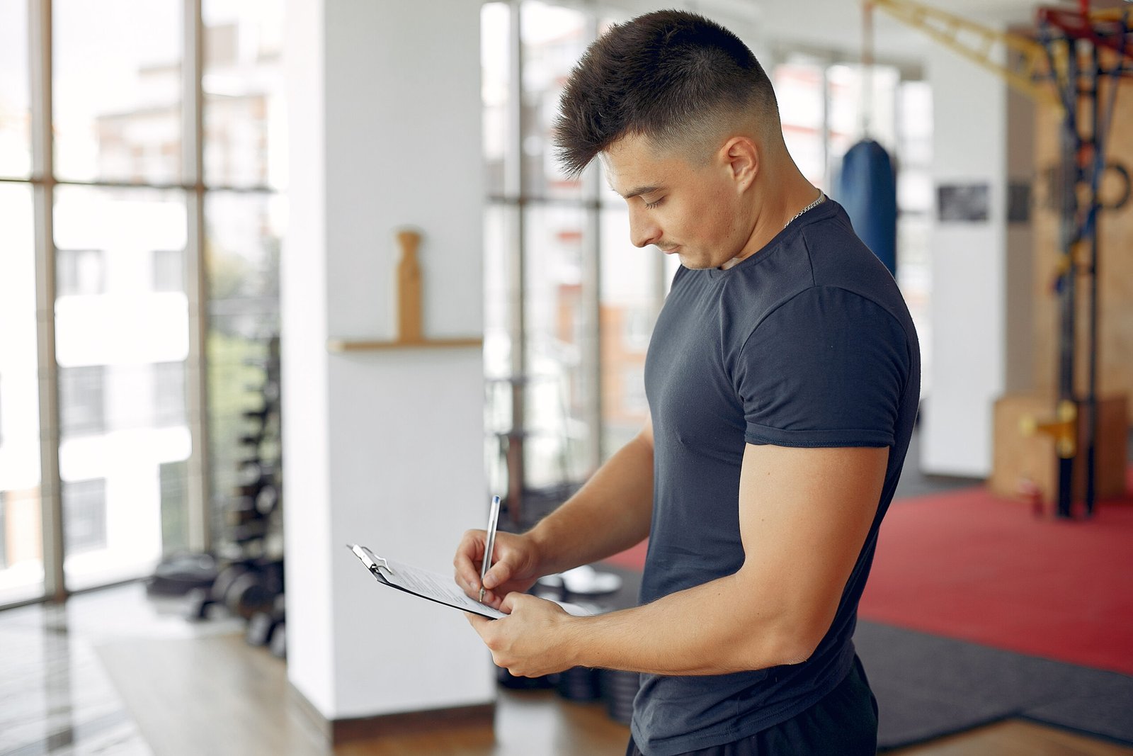 Athletic man working out with weights during morning gym training session